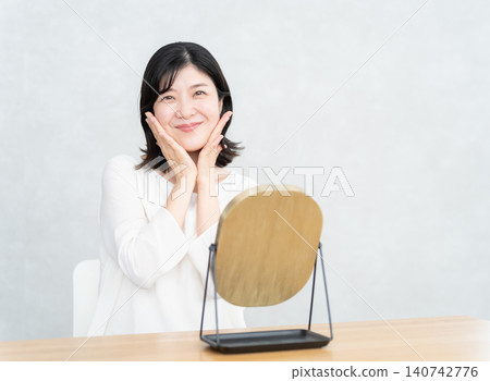 Middle-aged woman doing skin care Middle-aged woman doing skin care 140742776