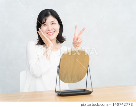 Middle-aged woman doing skin care Middle-aged woman doing skin care 140742778