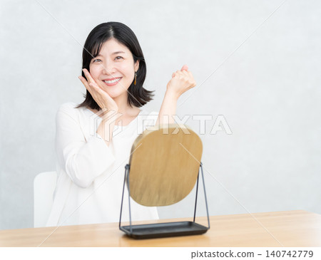 Middle-aged woman doing skin care Middle-aged woman doing skin care 140742779