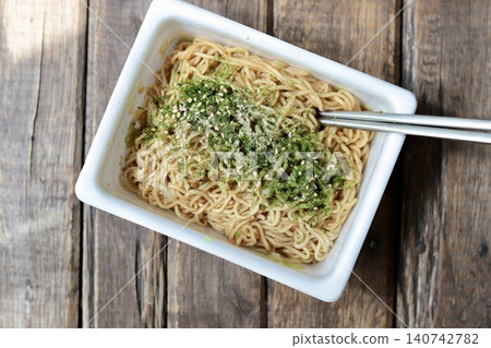 Instant cup noodles with plenty of dried seaweed flakes and yakisoba sauce. Instant cup noodles with plenty of dried seaweed flakes and yakisoba sauce. 140742782