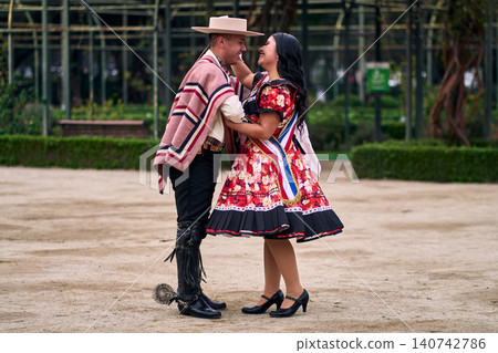 A pair of young Chilean Latin dancers dancing cuecas, the Chilean national dance, in a very cheerful, charismatic, and romantic manner. Chilean Independence Day A pair of young Chilean Latin dancers dancing cuecas, the Chilean national dance, in a very cheerful, charismatic, and romantic manner. Chilean Independence Day 140742786