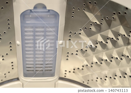 Lint filter inside a stainless steel top-loading washing machine Lint filter inside a stainless steel top-loading washing machine 140743113