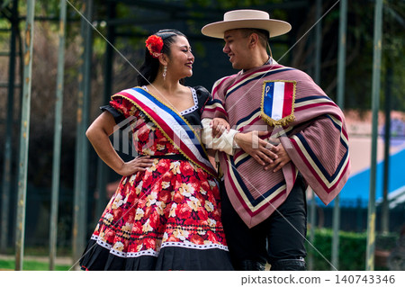 Portrait of a smiling young couple, dressed as Chilean huasos, looking at each other Portrait of a smiling young couple, dressed as Chilean huasos, looking at each other 140743346
