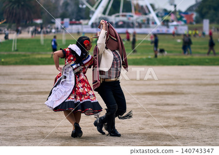A pair of young Chilean Latin dancers dancing cuecas A pair of young Chilean Latin dancers dancing cuecas 140743347