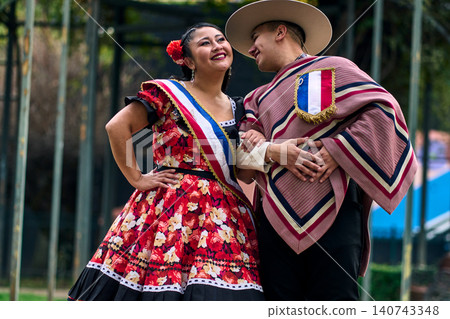Portrait of a smiling young couple, dressed as Chilean huasos, looking at each other Portrait of a smiling young couple, dressed as Chilean huasos, looking at each other 140743348