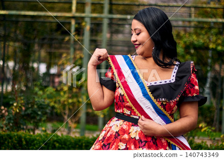 Portrait of a beautiful young woman smiling, cheerfully dressed as a Chilean huasa Portrait of a beautiful young woman smiling, cheerfully dressed as a Chilean huasa 140743349