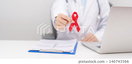 Doctor giving red ribbon to patient for concept of December World Aids Day, MADD, October Red ribbon week, February Heart month, Marfan Syndrome, May Stroke awareness, March world TB Tuberculosis Doctor giving red ribbon to patient for concept of December World Aids Day, MADD, October Red ribbon week, February Heart month, Marfan Syndrome, May Stroke awareness, March world TB Tuberculosis 140743566