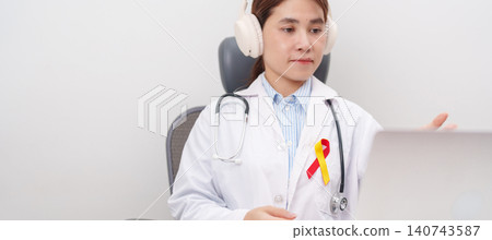 World hepatitis day awareness month, 28 July. doctor using laptop for telehealth, online consultation and meeting about Red and Yellow ribbon for Liver cancer, Jaundice, Cirrhosis, Failure, Enlarged World hepatitis day awareness month, 28 July. doctor using laptop for telehealth, online consultation and meeting about Red and Yellow ribbon for Liver cancer, Jaundice, Cirrhosis, Failure, Enlarged 140743587