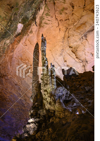 Stalactites and stalagmites colored by light in huge Yellow Dragon Cave near Zhangjiajie, China 140743623