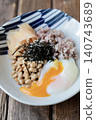 Natto rice with sixteen grains, topped with a soft-boiled egg and pickled young ginger. 140743689