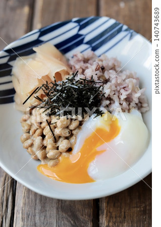 Natto rice with sixteen grains, topped with a soft-boiled egg and pickled young ginger. Natto rice with sixteen grains, topped with a soft-boiled egg and pickled young ginger. 140743689