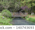 Small wooden bridge over a pond in the Yellow Dragon Park in the mountains near Zhangjiajie, China 140743693