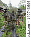 Wooden water wheel system on a stream in Yellow Dragon Park in the mountains near Zhangjiajie, China 140743696