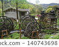 Wooden water wheel system on a stream in Yellow Dragon Park in the mountains near Zhangjiajie, China 140743698