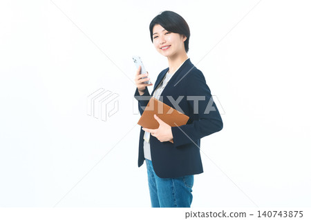She was holding her smartphone to her chest and carrying a brown file. She was holding her smartphone to her chest and carrying a brown file. 140743875