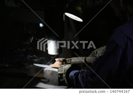 A craftsman who hammers heated materials into shapes A craftsman who hammers heated materials into shapes 140744167