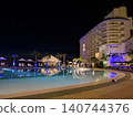 Nighttime pool and resort hotel ① 140744376