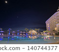 Nighttime pool and resort hotel ② 140744377
