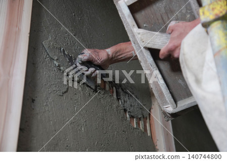 A man painting a clay wall A man painting a clay wall 140744800