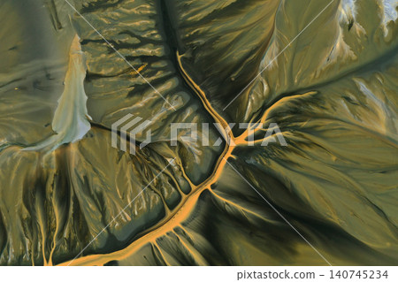 Aerial abstract surreal natural patterns above. Colorful chemical mining leach residues in decanting pond Aerial abstract surreal natural patterns above. Colorful chemical mining leach residues in decanting pond 140745234
