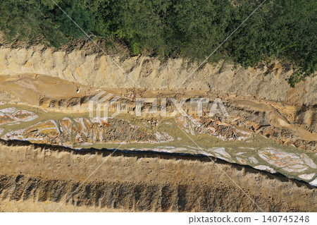 Aerial view of flowing toxic gold mining residual metal-rich water contaminates ecosystems. Rosia Montana, Romania Aerial view of flowing toxic gold mining residual metal-rich water contaminates ecosystems. Rosia Montana, Romania 140745248