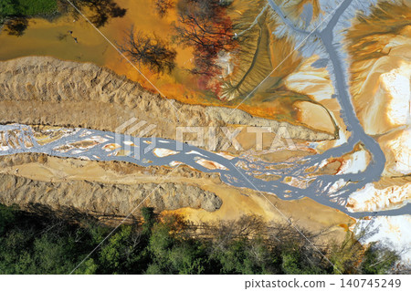 Aerial view of flowing toxic gold mining residual metal-rich water contaminates ecosystems. Rosia Montana, Romania 140745249
