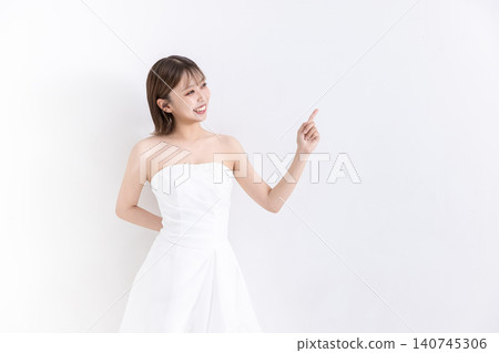 Bride pointing in front of a white background Bride pointing in front of a white background 140745306