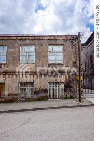 Decaying urban structure with multiple windows, showing signs of neglect Decaying urban structure with multiple windows, showing signs of neglect 140745380