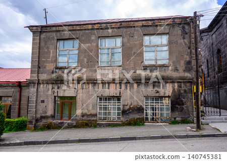 Abandoned two-story structure with peeling paint and cracked glass panes Abandoned two-story structure with peeling paint and cracked glass panes 140745381