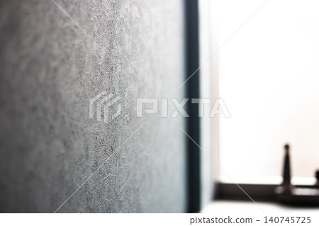 The room is filled with natural light streaming in through a small window. The room is filled with natural light streaming in through a small window. 140745725