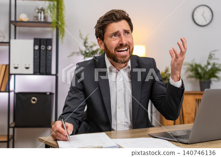 Middle-aged businessman lawyer reviews contracts finds mistake facepalm then corrects with pen fast Middle-aged businessman lawyer reviews contracts finds mistake facepalm then corrects with pen fast 140746136