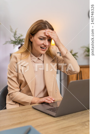 Businesswoman faces laptop system crash data loss holds head facepalm error pops up failure reaction Businesswoman faces laptop system crash data loss holds head facepalm error pops up failure reaction 140746326