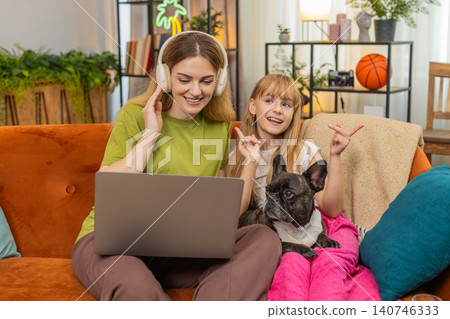 Mother daughter dog wireless headphones music work on laptop sing along together focus create flow Mother daughter dog wireless headphones music work on laptop sing along together focus create flow 140746333