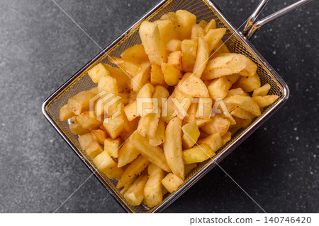 Golden French fries fried with salt and spices, unhealthy takeaway food. French fries Golden French fries fried with salt and spices, unhealthy takeaway food. French fries 140746420