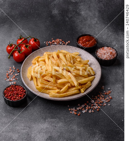 Golden French fries fried with salt and spices, unhealthy takeaway food. French fries Golden French fries fried with salt and spices, unhealthy takeaway food. French fries 140746429