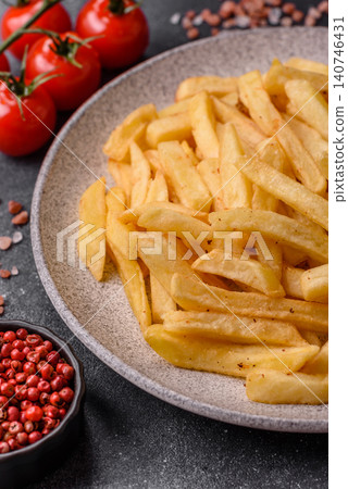 Golden French fries fried with salt and spices, unhealthy takeaway food. French fries Golden French fries fried with salt and spices, unhealthy takeaway food. French fries 140746431