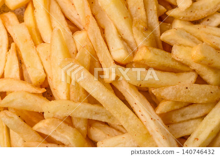 Golden French fries fried with salt and spices, unhealthy takeaway food. French fries Golden French fries fried with salt and spices, unhealthy takeaway food. French fries 140746432