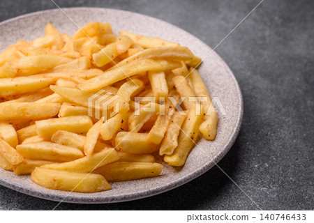 Golden French fries fried with salt and spices, unhealthy takeaway food. French fries 140746433