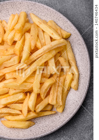 Golden French fries fried with salt and spices, unhealthy takeaway food. French fries Golden French fries fried with salt and spices, unhealthy takeaway food. French fries 140746434