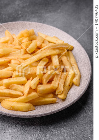 Golden French fries fried with salt and spices, unhealthy takeaway food. French fries 140746435