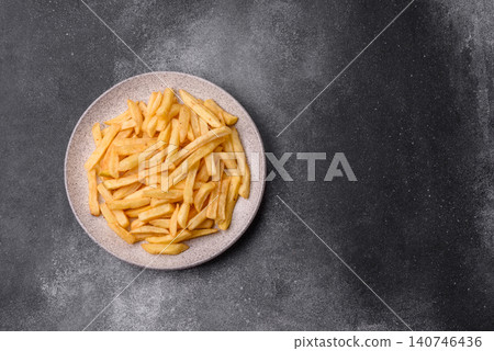 Golden French fries fried with salt and spices, unhealthy takeaway food. French fries Golden French fries fried with salt and spices, unhealthy takeaway food. French fries 140746436