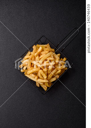 Golden French fries fried with salt and spices, unhealthy takeaway food. French fries Golden French fries fried with salt and spices, unhealthy takeaway food. French fries 140746439