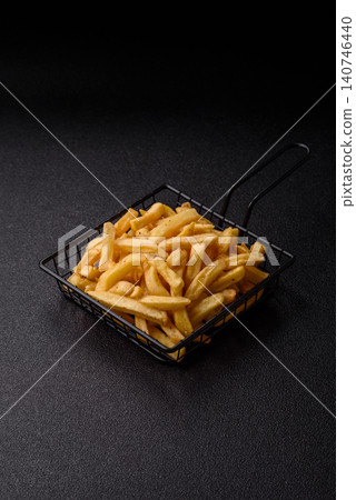 Golden French fries fried with salt and spices, unhealthy takeaway food. French fries Golden French fries fried with salt and spices, unhealthy takeaway food. French fries 140746440