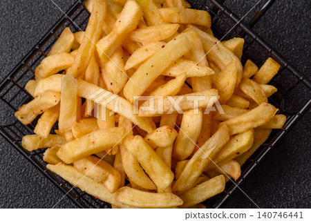 Golden French fries fried with salt and spices, unhealthy takeaway food. French fries 140746441