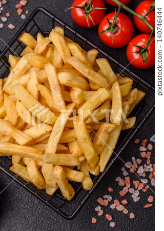 Golden French fries fried with salt and spices, unhealthy takeaway food. French fries Golden French fries fried with salt and spices, unhealthy takeaway food. French fries 140746444