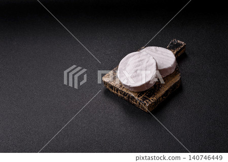 Brie or Camembert cheese is a white, round shape for baking and melting. Camembert cheese Brie or Camembert cheese is a white, round shape for baking and melting. Camembert cheese 140746449