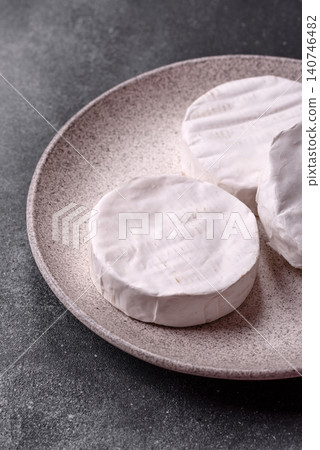 Brie or Camembert cheese is a white, round shape for baking and melting. Camembert cheese Brie or Camembert cheese is a white, round shape for baking and melting. Camembert cheese 140746482