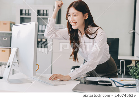 Young businesswoman professional employee using pc doing online banking analysing at workplace. Asian middle-aged business woman working on laptop computer in office, taking notes. Banner, copy space 140746629