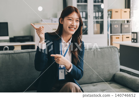 Asian businesswoman sitting at work using laptop talking and consulting in office Asian businesswoman sitting at work using laptop talking and consulting in office 140746652