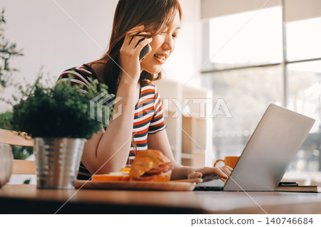 Happiness Entrepreneur beautiful business asian young woman wear casual use mobile phone for shopping online enjoy with social media and laptop at home.Small Business Startup.online banking 140746684